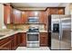 Spacious kitchen features granite countertops, stainless steel appliances, and wood cabinets at 2727 S Equestrian Dr # 103, Gilbert, AZ 85295
