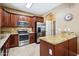 Well-equipped kitchen with stainless steel appliances, dark wood cabinets, and a functional island for meal preparation at 2727 S Equestrian Dr # 103, Gilbert, AZ 85295