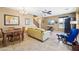 Open-concept living and dining area with comfortable seating, a dining table, and a view of the entertainment center at 2727 S Equestrian Dr # 103, Gilbert, AZ 85295