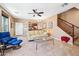 Bright and airy living room featuring comfortable seating, stairs to the second floor, and a view into the kitchen at 2727 S Equestrian Dr # 103, Gilbert, AZ 85295