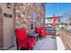 Cozy outdoor seating area with comfortable red chairs, perfect for enjoying the fresh air and sunshine at 2727 S Equestrian Dr # 103, Gilbert, AZ 85295