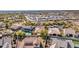 Wide aerial view of a home with solar panels, backyard pool and community landscape at 2957 N Riley Ct, Buckeye, AZ 85396