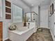 Relaxing main bathroom with a large soaking tub, glass shower and decorative tile floors at 2957 N Riley Ct, Buckeye, AZ 85396