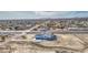 An aerial view of a home with an attached three-car garage, nestled in the desert at 30634 W Latham St, Buckeye, AZ 85326