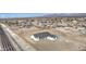 An aerial view of a modern white home nestled within a sprawling desert landscape at 30634 W Latham St, Buckeye, AZ 85326