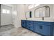 Bathroom with a double vanity, modern mirrors, and tile flooring at 30634 W Latham St, Buckeye, AZ 85326