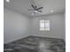 Bright bedroom with a modern ceiling fan, recessed lighting, and large tile floor at 30634 W Latham St, Buckeye, AZ 85326