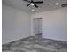 View of the bedroom showcasing a door, recessed lighting, and large tile flooring at 30634 W Latham St, Buckeye, AZ 85326