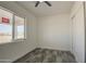 Bedroom featuring a window, closet, and dark tile flooring at 30634 W Latham St, Buckeye, AZ 85326