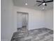 View of the bedroom showcasing an open doorway, recessed lighting, and large tile flooring at 30634 W Latham St, Buckeye, AZ 85326