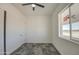 Bedroom featuring a window, closet, and dark tile flooring at 30634 W Latham St, Buckeye, AZ 85326