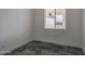 Bedroom featuring a window, dark tile flooring, and white walls at 30634 W Latham St, Buckeye, AZ 85326