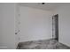 Bedroom with white walls, dark flooring, and white doors at 30634 W Latham St, Buckeye, AZ 85326
