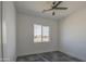 Bedroom featuring a window and dark tile flooring at 30634 W Latham St, Buckeye, AZ 85326