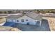 Aerial view of a white home featuring a spacious three-car garage and covered patio at 30634 W Latham St, Buckeye, AZ 85326