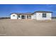 An eye-level shot of a bright, white single-story home with black trim and a desert landscape in the front yard at 30634 W Latham St, Buckeye, AZ 85326