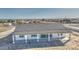 A single-story home with a gray tiled roof has large windows and a covered patio at 30634 W Latham St, Buckeye, AZ 85326