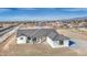 A charming single-story home with a gray tiled roof sits on a large lot ready for landscaping at 30634 W Latham St, Buckeye, AZ 85326