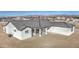 Aerial view of a white home featuring a spacious covered patio with columns at 30634 W Latham St, Buckeye, AZ 85326