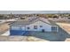 Aerial view of a white home featuring a spacious three-car garage and covered patio at 30634 W Latham St, Buckeye, AZ 85326