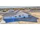 Aerial view of a white home featuring a spacious three-car garage and covered patio at 30634 W Latham St, Buckeye, AZ 85326