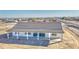 New construction home features a covered patio with white pillars and a gray roof at 30634 W Latham St, Buckeye, AZ 85326