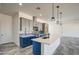 Modern kitchen features gray cabinets, white countertops, island and pendants at 30634 W Latham St, Buckeye, AZ 85326