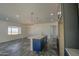 Open kitchen with white island, gray cabinets and modern pendant lighting at 30634 W Latham St, Buckeye, AZ 85326