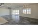 Bright living room with sliding glass doors, tile floors, and ceiling fan at 30634 W Latham St, Buckeye, AZ 85326