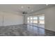 Living room with sliding doors to patio and gray tile floors at 30634 W Latham St, Buckeye, AZ 85326