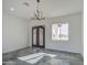 Living room with decorative iron front doors, window and tiled floors at 30634 W Latham St, Buckeye, AZ 85326