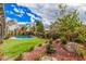 The large backyard features an inviting pool, rock landscaping, palm trees and artificial grass at 3431 E Kristal Way, Phoenix, AZ 85050