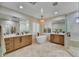 Luxury bathroom featuring dual vanities, standalone tub, and a glass-enclosed shower at 3812 E Parkside Ln, Phoenix, AZ 85050