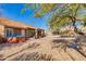 Spacious backyard features a hot tub, covered patio, and gravel desert landscaping at 4044 E Cascalote Dr, Cave Creek, AZ 85331