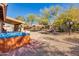 Backyard with a hot tub and covered patio, perfect for outdoor entertaining and relaxation at 4044 E Cascalote Dr, Cave Creek, AZ 85331