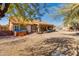Desert backyard showcasing the hot tub, gravel landscaping, and covered patio area at 4044 E Cascalote Dr, Cave Creek, AZ 85331