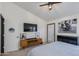 Modern bedroom featuring a wall-mounted TV, stylish console table, and motorcycle-themed decor at 4044 E Cascalote Dr, Cave Creek, AZ 85331