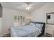 Comfortable bedroom with a ceiling fan, white shutters, and blue patterned bedding, creating a relaxing retreat at 4044 E Cascalote Dr, Cave Creek, AZ 85331