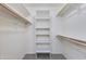 Walk-in closet with ample shelving and wooden hanging rods, perfect for organizing clothes and accessories at 4044 E Cascalote Dr, Cave Creek, AZ 85331