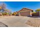 Single-story house with desert landscaping, concrete driveway leading to a two-car garage under a blue sky at 4044 E Cascalote Dr, Cave Creek, AZ 85331