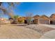 Inviting single-story home featuring desert landscaping, a two car garage and a cozy covered front porch at 4044 E Cascalote Dr, Cave Creek, AZ 85331