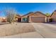 Charming home featuring desert landscaping, a two-car garage, and welcoming covered porch under clear blue skies at 4044 E Cascalote Dr, Cave Creek, AZ 85331