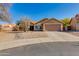 Charming single-story home with a two car garage and low maintenance desert landscaping under a clear blue sky at 4044 E Cascalote Dr, Cave Creek, AZ 85331