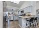 Well-lit kitchen featuring stainless steel appliances, granite countertops, and a breakfast bar with seating at 4044 E Cascalote Dr, Cave Creek, AZ 85331