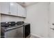 Laundry room featuring a modern washer and dryer with overhead cabinets at 4044 E Cascalote Dr, Cave Creek, AZ 85331