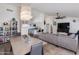 Bright, open living space featuring a modern chandelier, comfortable seating, and easy access to the kitchen at 4044 E Cascalote Dr, Cave Creek, AZ 85331