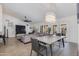 Open-concept living room and dining area featuring contemporary decor, large windows, and a comfortable gray sofa at 4044 E Cascalote Dr, Cave Creek, AZ 85331