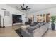 Bright and airy living room with a large sectional, ceiling fan, and comfortable leather chair at 4044 E Cascalote Dr, Cave Creek, AZ 85331