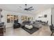 Spacious living room with a large sectional, ceiling fan, and plenty of natural light from the many windows at 4044 E Cascalote Dr, Cave Creek, AZ 85331