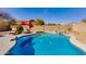 Beautiful pool featuring desert landscaping, a rock waterfall feature, and privacy wall at 4044 E Cascalote Dr, Cave Creek, AZ 85331